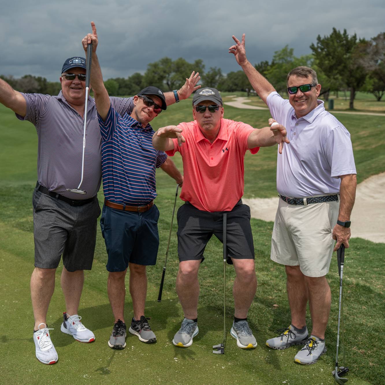 golfers with their arms in the air