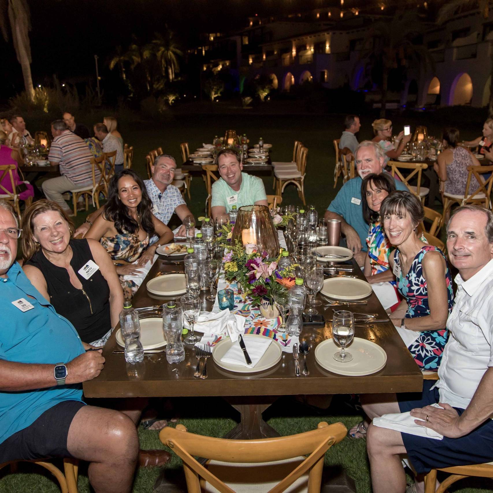 people smiling around a dinner table